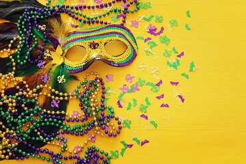 Holidays image of mardi gras masquarade venetian mask over yellow background. view from above © tomertu