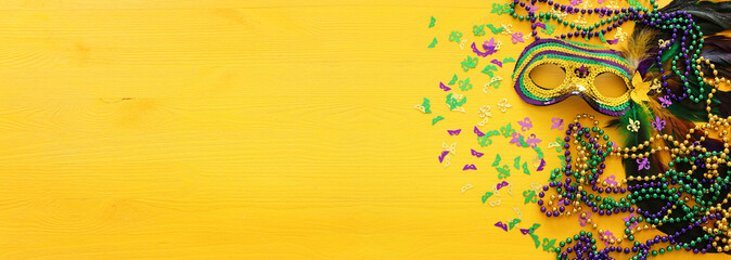 Holidays image of mardi gras masquarade venetian mask over yellow background. view from above
