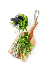 Make seasoning and condiments. Herbs in mortar on white background top-down