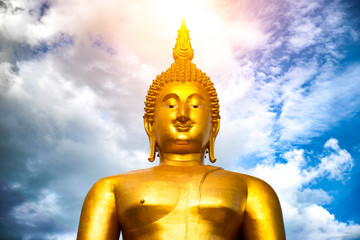 Makha Bucha Day, Visakha Bucha, a large shadow Buddha statue behind a golden sunset in Thailand