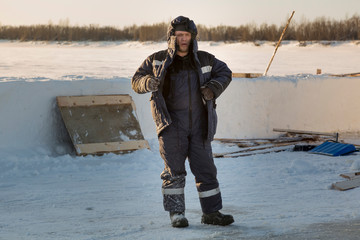 Portrait of a worker in protective workwear with a hood on his head