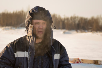 Portrait of a worker in protective workwear with a hood on his head