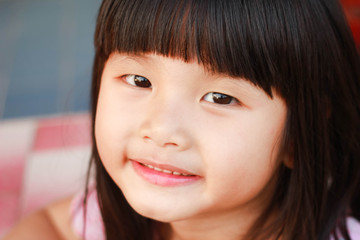 A little asian girl with a bright smile , Outdoor portrait , Thailand.