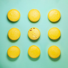 Yellow macaroons on blue background. Square form