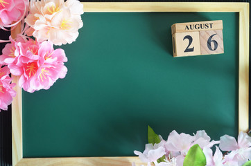 August 26, Japanese Cover, Number cube of date with sakura flower on the wood green board.