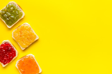 Toast with jam. Colorful set on yellow background top-down frame copy space