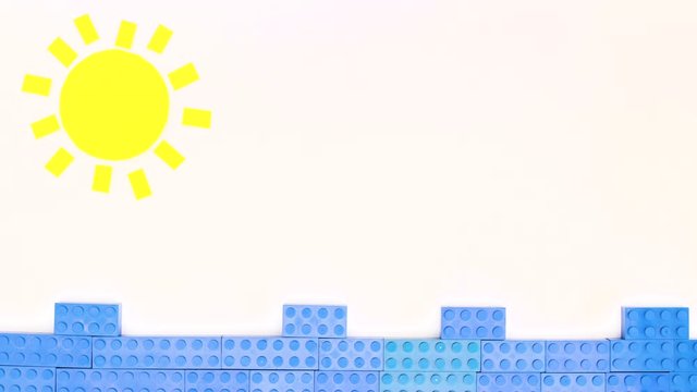 Sun and moving waves made of toy bricks - Looping stop motion