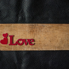  Valentine's Day card. Word Love with red hearts on wooden background. Greeting card concept. Top view