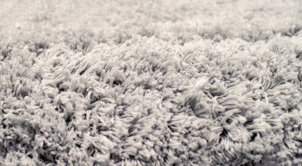 Texture of long-pile carpet. Abstract background of a shaggy grey carpet pile texture with long...