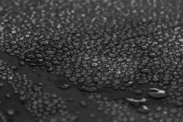 different drops of water on a black background