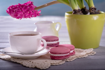 Pink macaroon with pink  hyacinth on the wooden background
