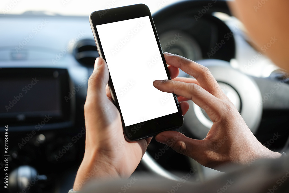 Poster cropped shot view the driver uses the phone while driving. modern smart phone with round edges. isol