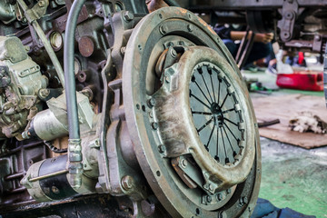 Old rusted car engine and clutch disc.
