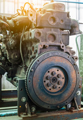 Old rusted car engine and clutch disc.