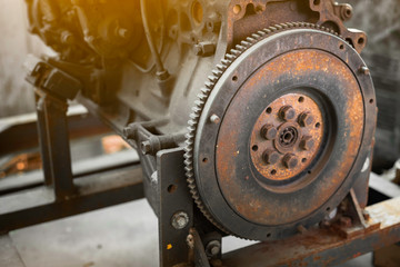 Old rusted car engine and clutch disc.