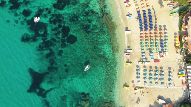 Capo Vaticano, Calabria, Italy. Aerial top down view of the beach, umbrellas and boats