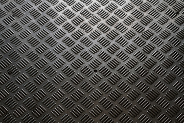 Background of seamless pattern and textured of the vintage steel checker plate with soft lighting.