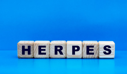 concept word herpes on cubes on a blue background