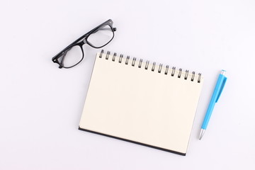 Top view blank notebook with pen on white background