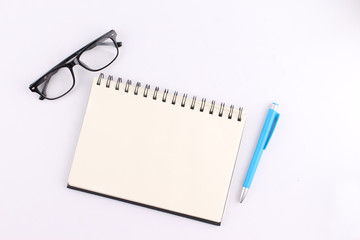 Top view blank notebook with pen on white background