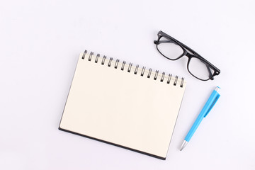 Top view blank notebook with pen on white background