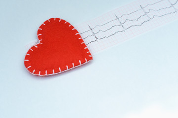 Cardiogram paper tape on a table with a red heart. Cardiogram of the heart. Your text