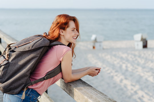 Young woman hiker or backpacker at the beach