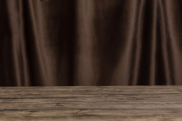Obraz premium old wooden table on background velvet curtain