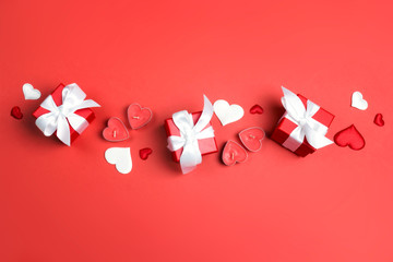 Gifts, hearts and candles on red background. Valentine's day concept.