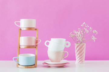 modern cups on white table on background pink wall