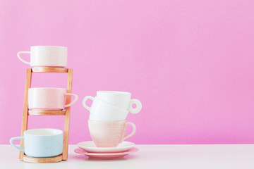 modern cups on white table on background pink wall