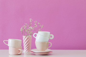 modern cups on white table on background pink wall