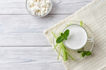 Pouring homemade kefir, yogurt with probiotics. Probiotic cold sour-milk drink. Fashionable food and drinks.