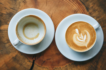 Full and empty cup of coffee. The concept of beginning and end, start and finish.