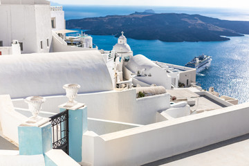 Fira capital of Santorini island and the view of volcanic caldera, Santorini, Greece. Beautiful white architecture, peaceful scenery with blue sea and sky. Summer travel vacation destination