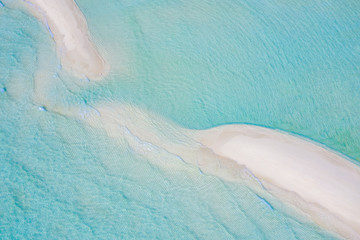 Beautiful aerial photo of exotic sandbank, idyllic tropical beach landscape, blue sea ripples and white sand. Romantic and relaxing summer mood background or wallpaper 