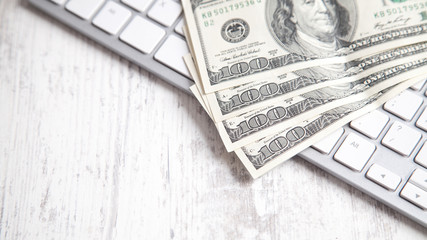 Hundred dollar banknotes with a computer keyboard.