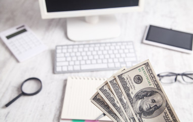 Hundred dollar banknotes on the business desk background.