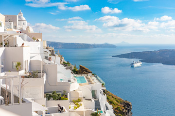 Fira capital of Santorini island and the view of volcanic caldera, Santorini, Greece. Beautiful white architecture, peaceful scenery with blue sea and sky. Summer travel vacation destination