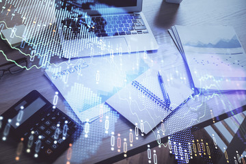 Financial graph colorful drawing and table with computer on background. Double exposure. Concept of international markets.