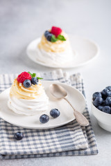 Delicious Pavlova cake with whipped cream and fresh berries. Selective focus