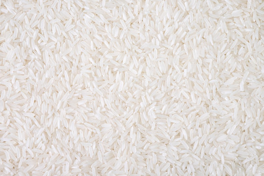Top view of white rice seed texture background. Organic, natural long rice grain, food for healthy. Agriculture of culture asian. Flay lay