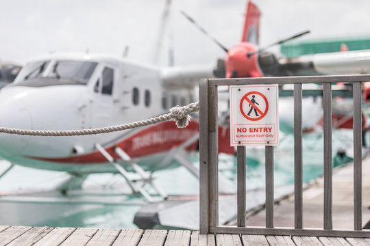 Male, Maldives – May 10, 2019: TMA - Trans Maldivian Airways Twin Otter seaplanes at Male airport (MLE) in the Maldives. Seaplane parking next to floating wooden jetty, Maldives