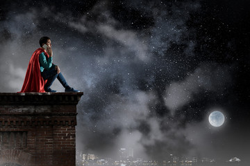 Super hero on roof. Mixed media