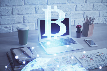 Double exposure of blockchain theme hologram and table with computer background. Concept of bitcoin...