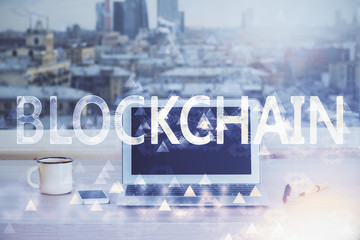 Double exposure of blockchain theme hologram and table with computer background. Concept of bitcoin crypto currency.