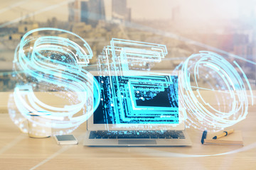 Multi exposure of table with computer and seo drawing hologram. Search optimization concept.