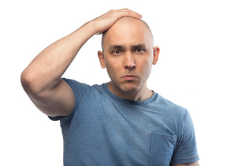 Portrait of bald man touching shaved head