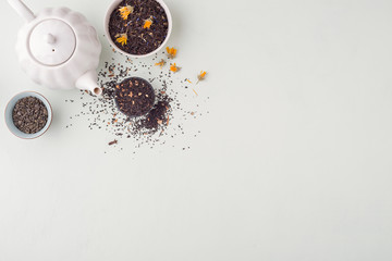 Set of different herbal and fruit dry teas on light table.