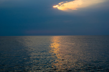 a beautiful sunrise at the sea. Boat and rocks near the shore